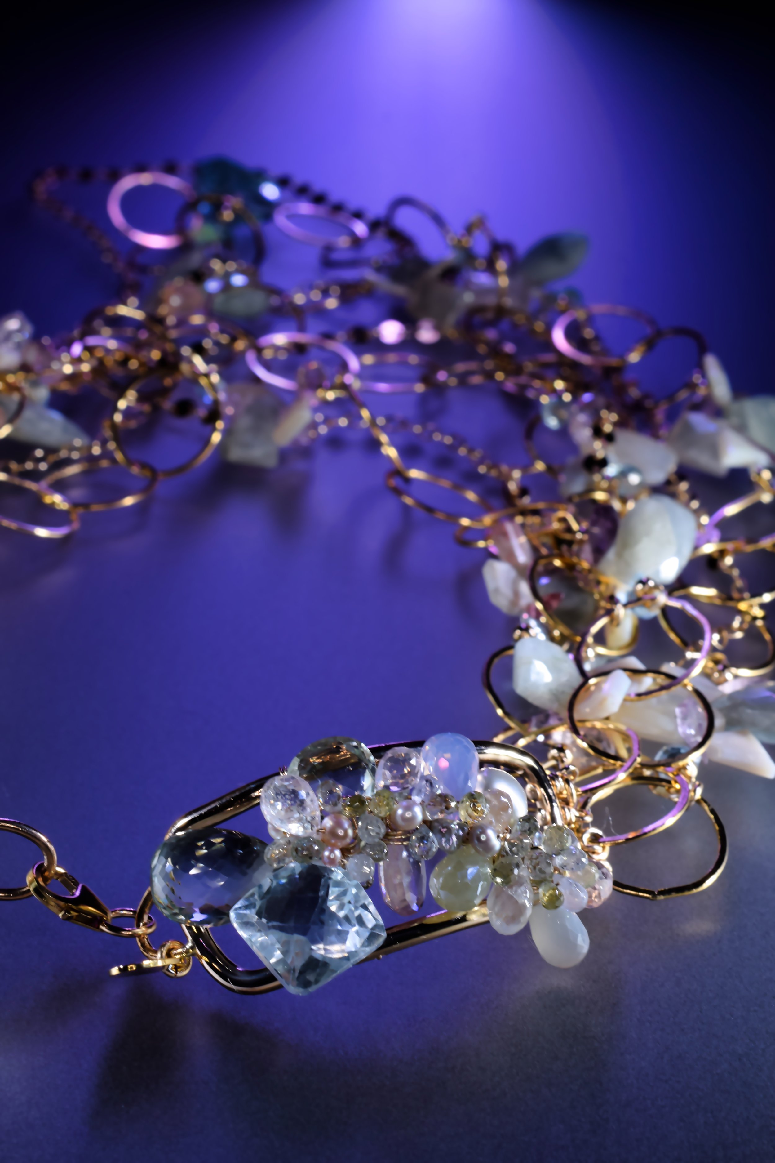 up close details of a handmade necklace clasp with pastel gemstones