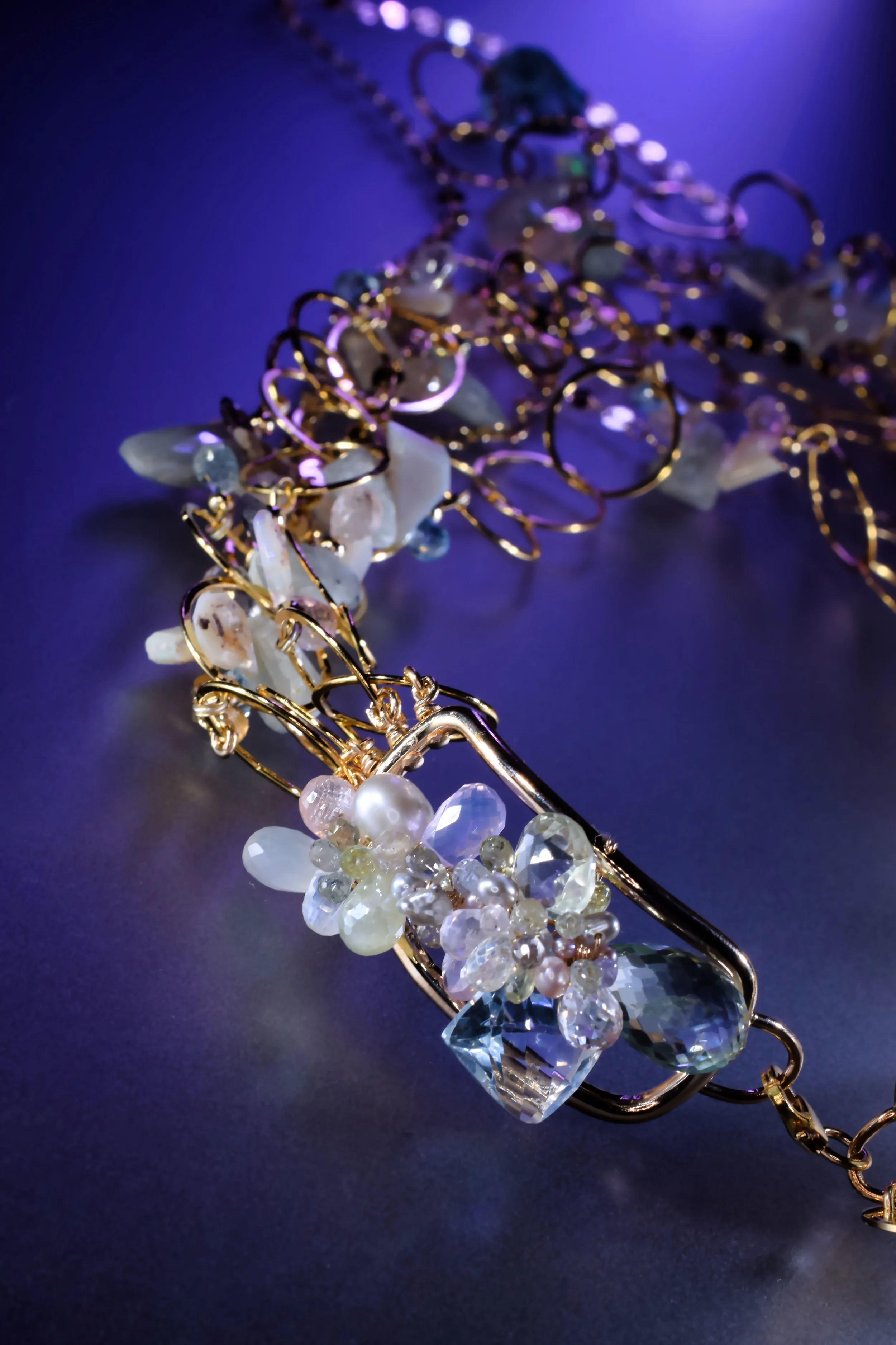 pastel gemstones woven into a necklace clasp