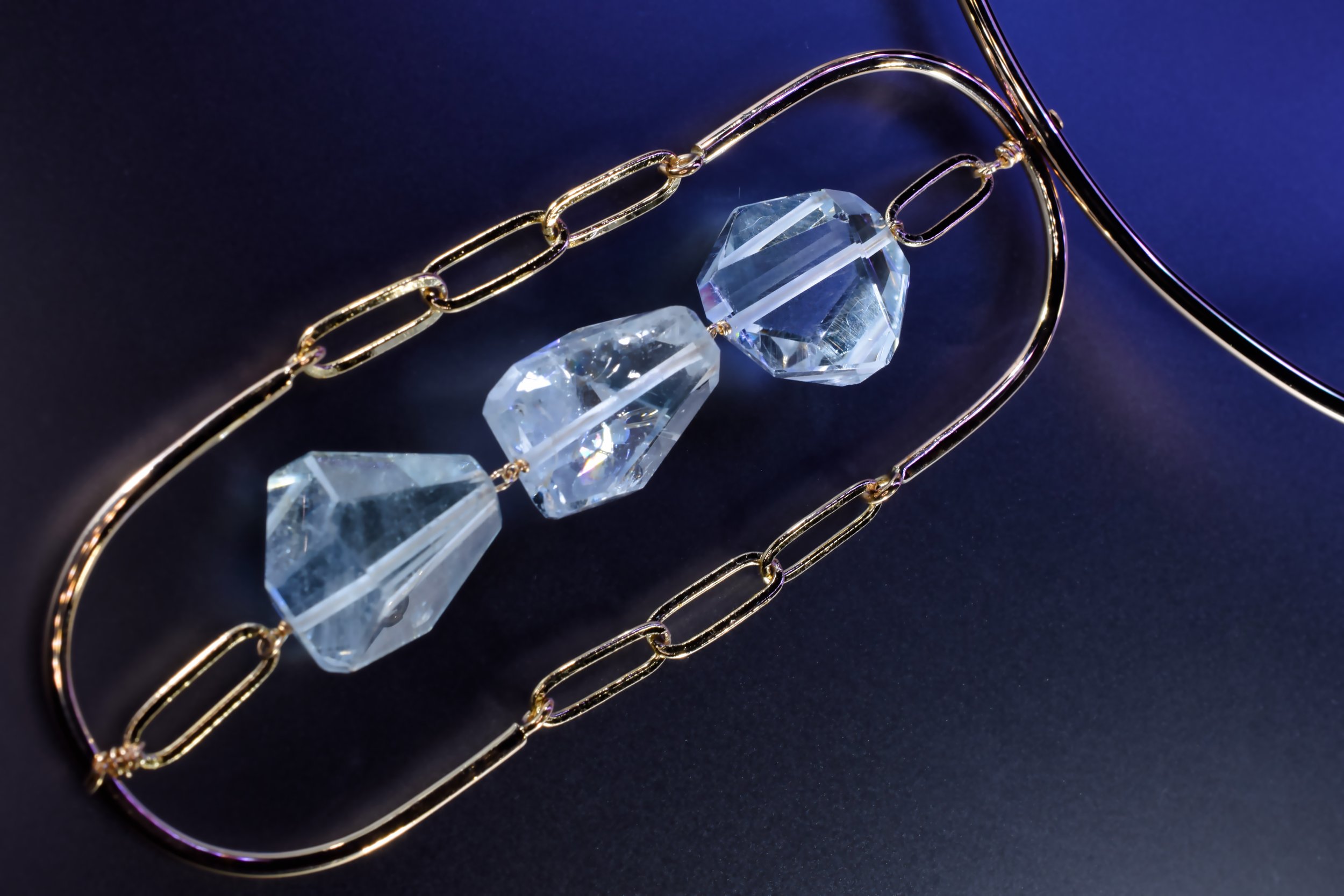 blue topaz pendant gemstones framed by gold frames and chains