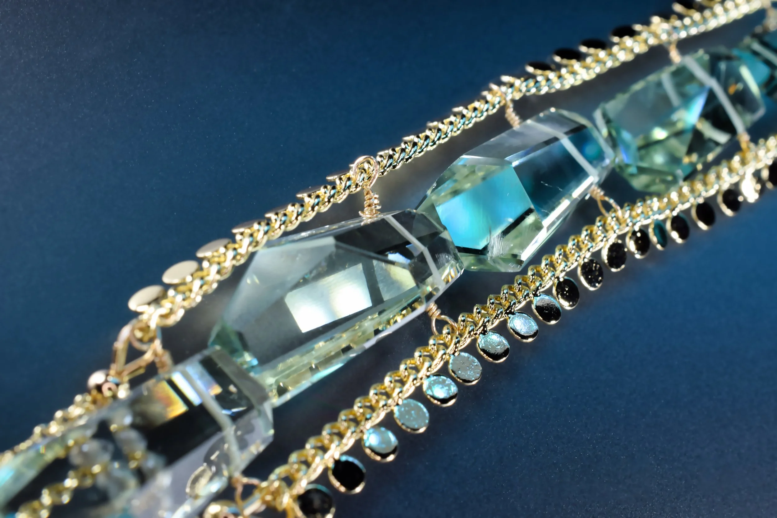 Vertical gemstone cluster necklace with gold chain fringe