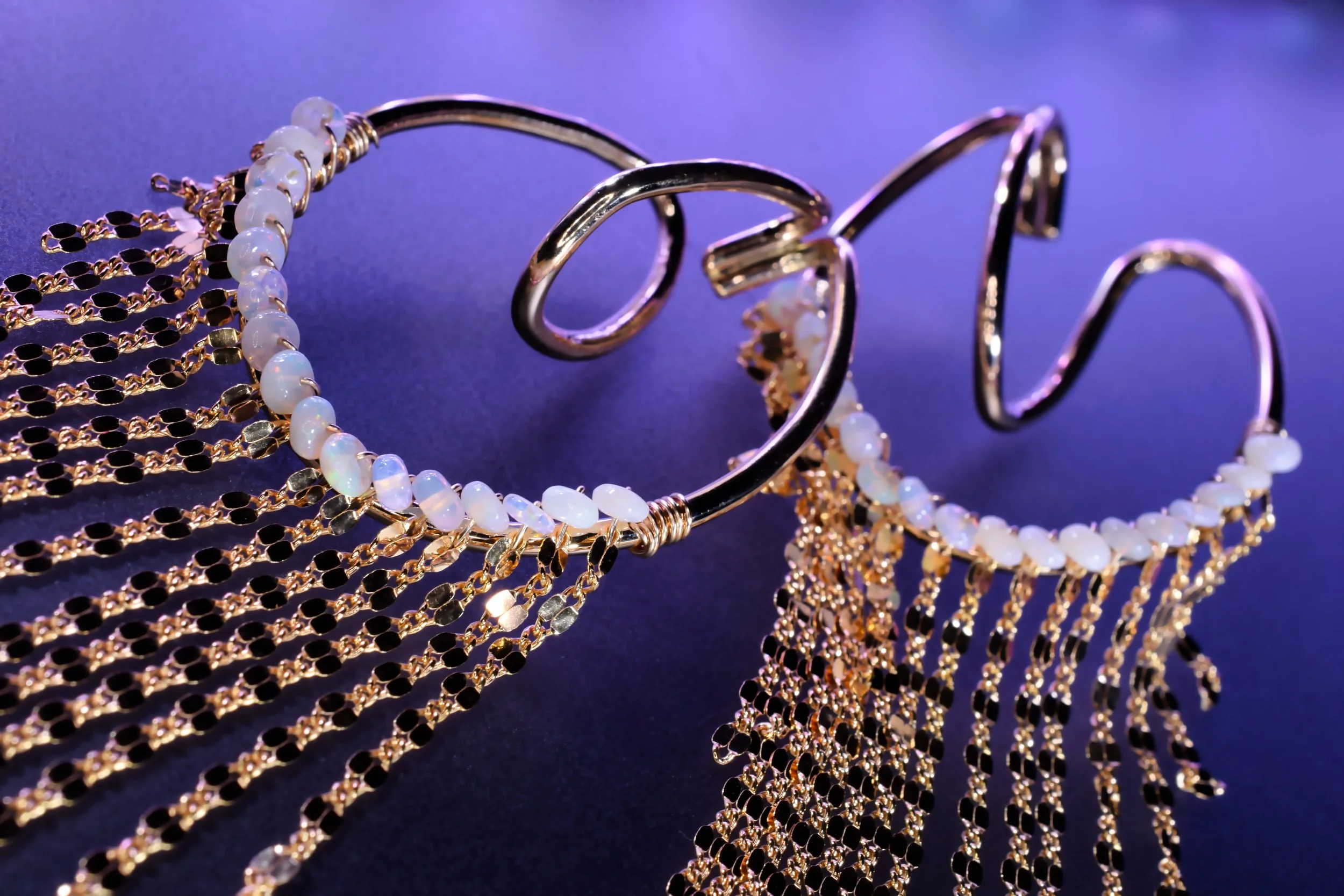 Gold ear cuffs with opal and chain tassels by designer Andrea Li 