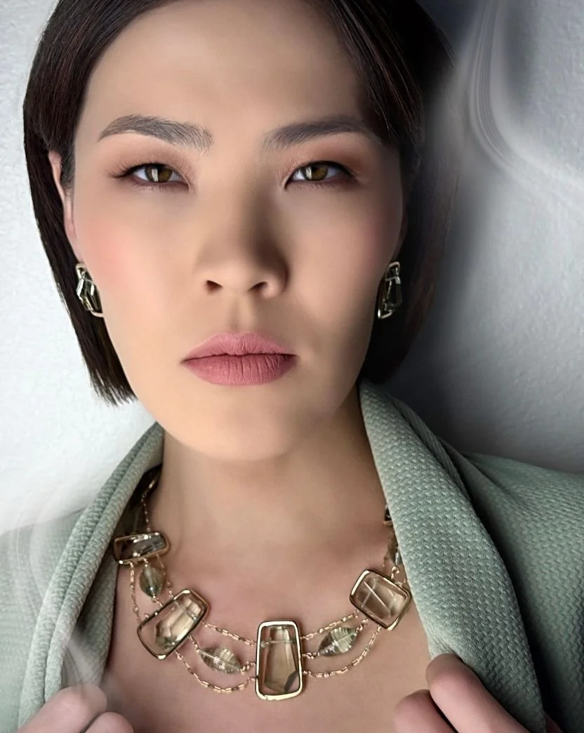 model wearing green amethyst collar necklace in green jacket.jpg