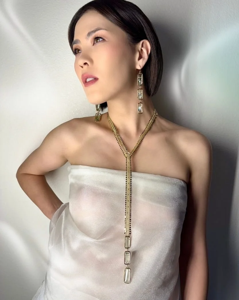 model wearing long elegant necklace and earrings.jpg