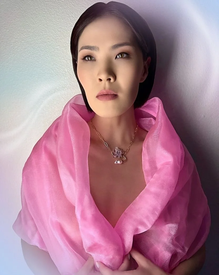 model wearing a pastel gemstone necklace with a Baroque pearl.jpg