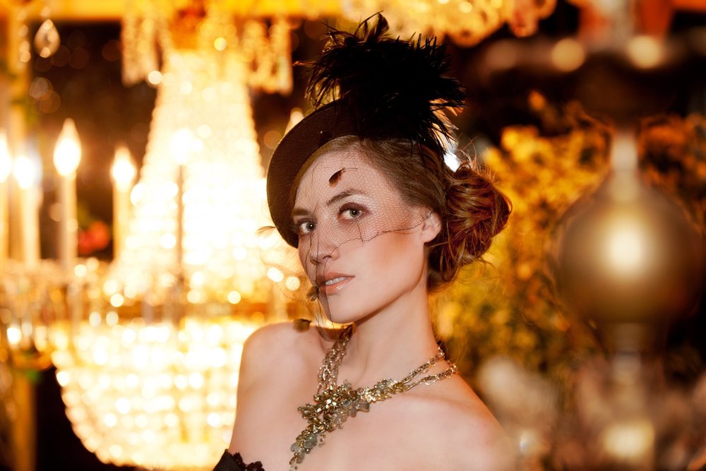 Brunette woman in vintage dress with gold necklace