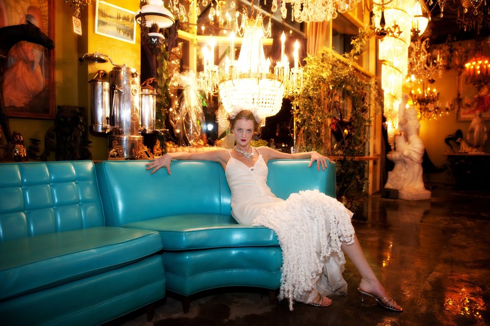 Woman sitting in vintage dress with gold necklace 