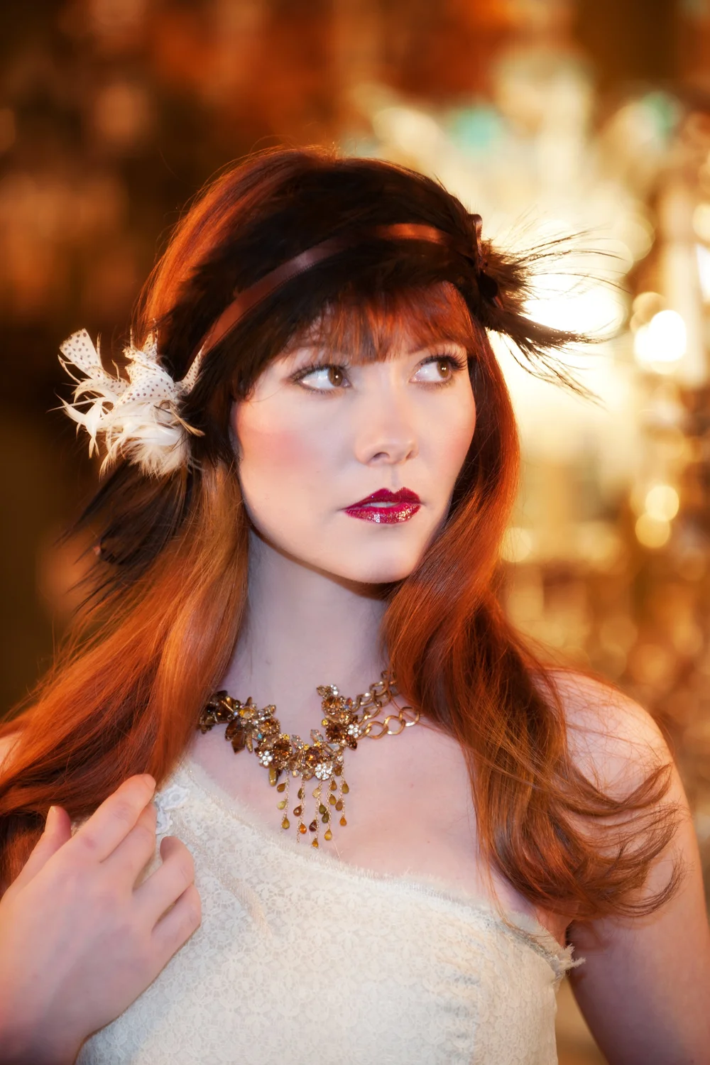 Redhead woman in vintage dress with gold necklace