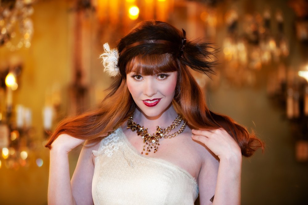 Redhead woman in vintage dress with gold necklace