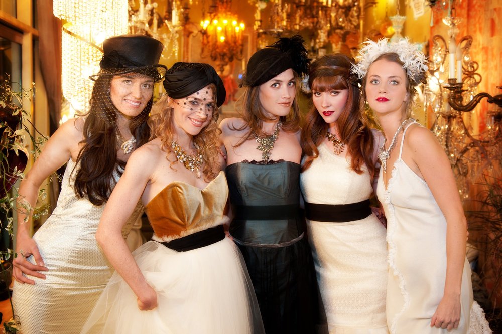 Group of women in vintage outfits and jewelry