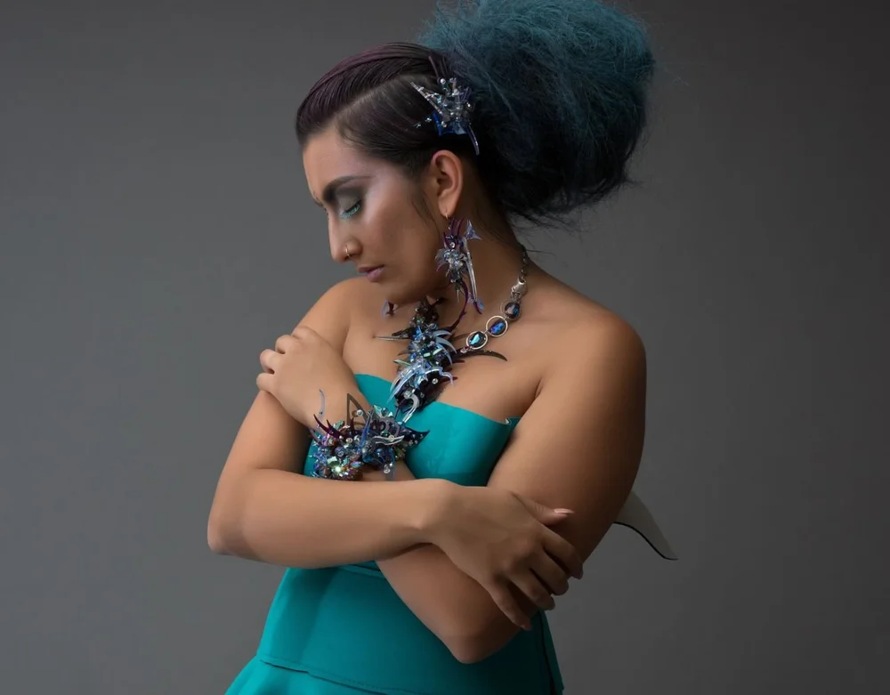 Woman in blue dress and colorful art jewelry