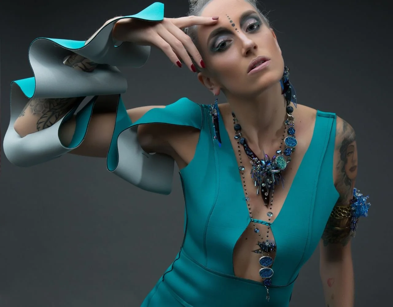 Woman in blue dress and colorful art jewelry