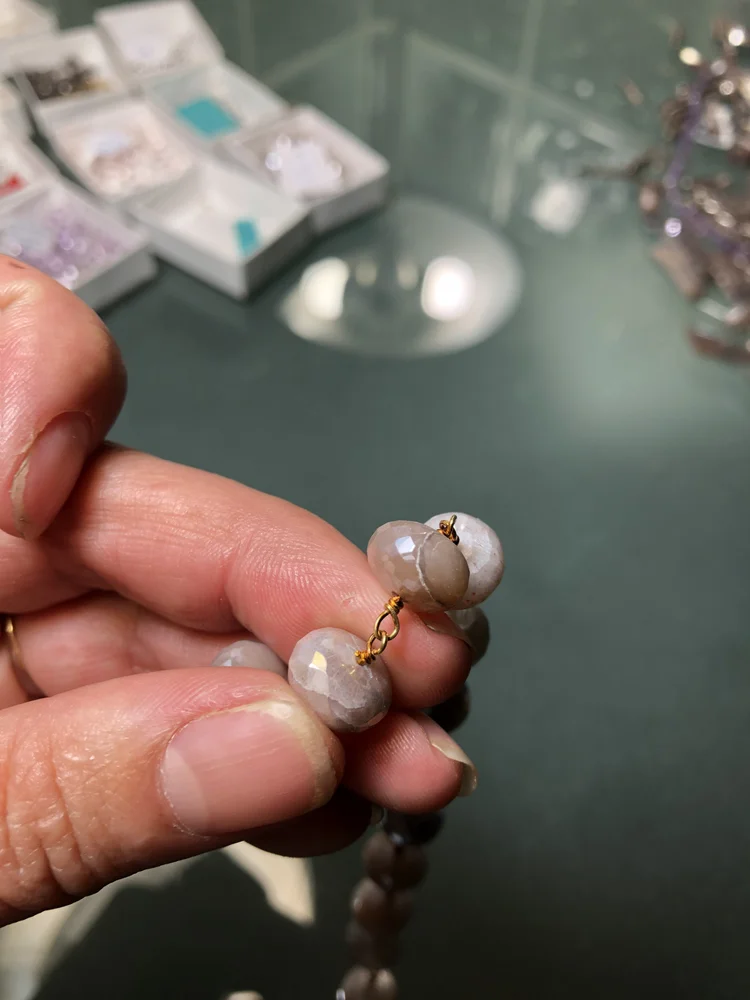 A hand holding an earring