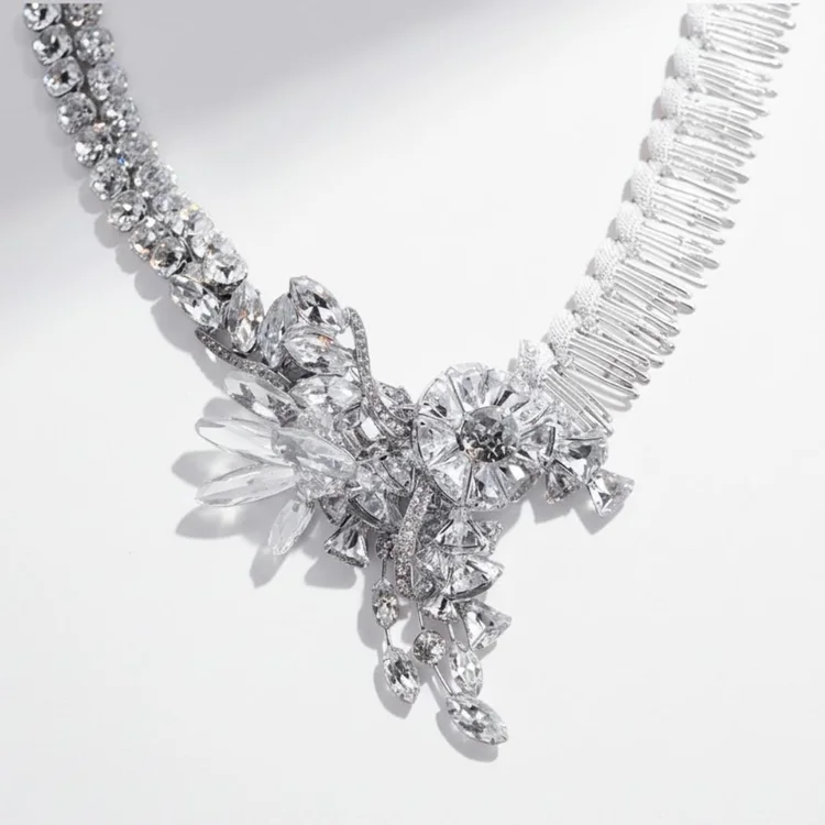 Silver vintage statement necklace with a cascading cluster of clear and frosted crystals