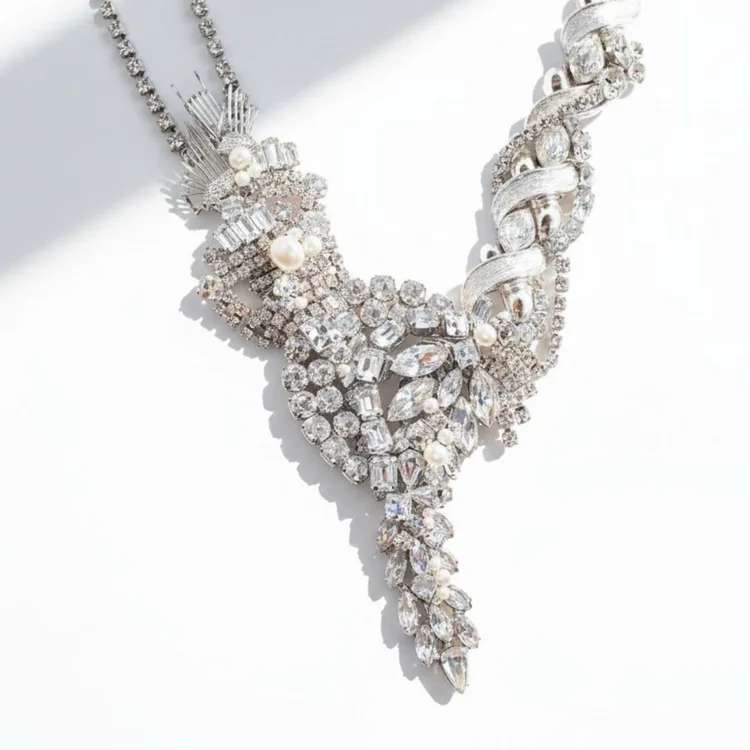 Silver vintage crystal necklace ending in a long cascade of clear stones