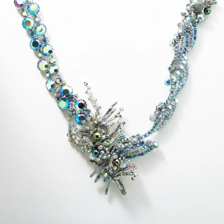 Silver vintage necklace with a cascading cluster of blue and iridescent crystals