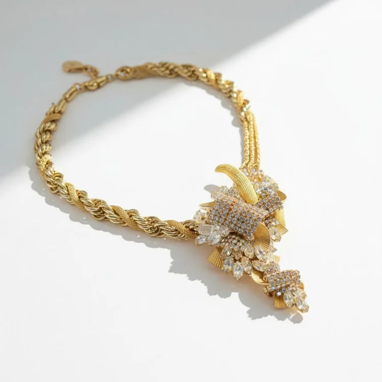Gold rope chain necklace with a crystal cluster and a gold hook accent