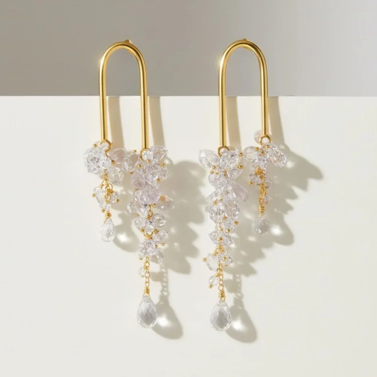 Gold paperclip hoop earrings with cascading clear crystal clusters and teardrop drops