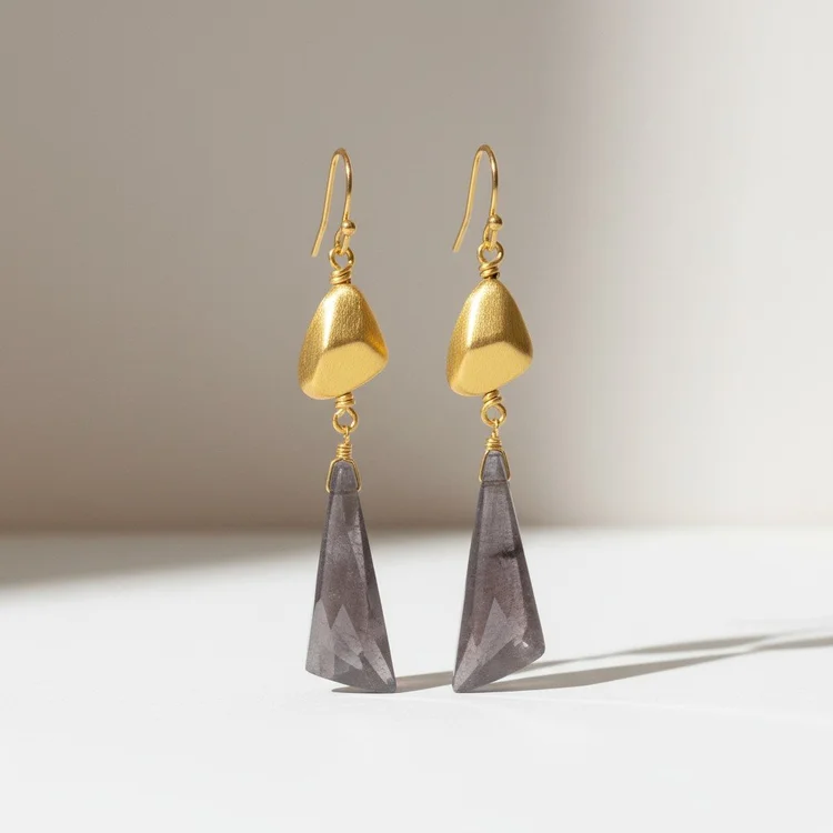 Earrings with brushed gold nuggets and long smoky violet crystal drops