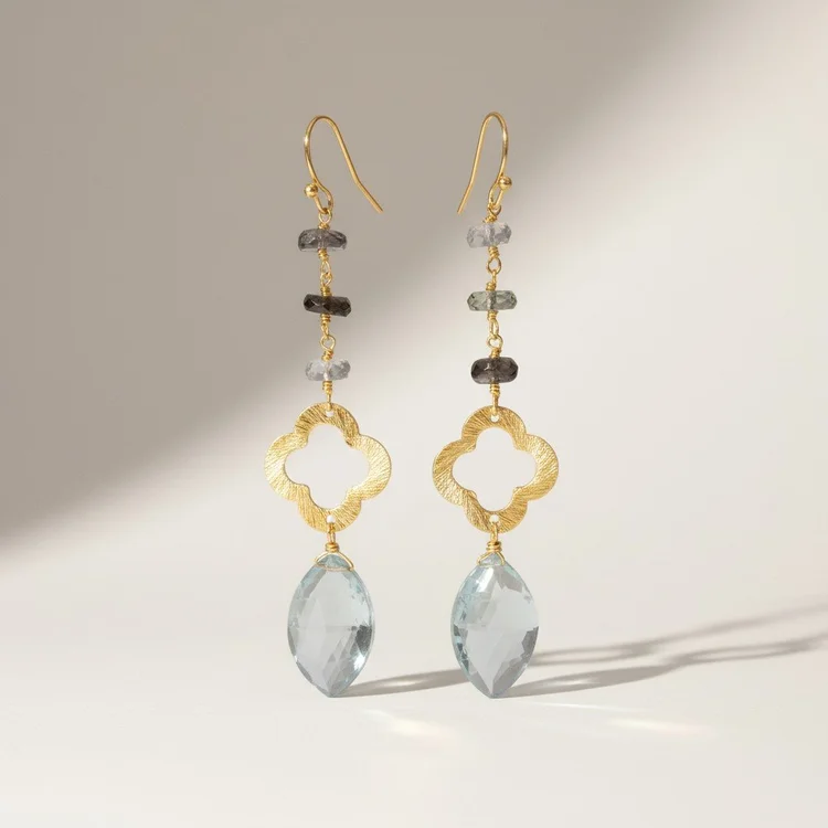 Gold quatrefoil drop earrings with gray stones and large pale aqua briolettes