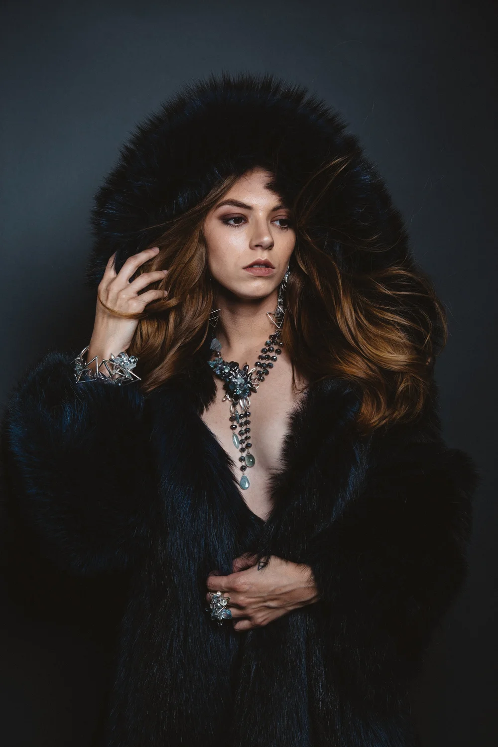 Caitlin wearing Andrea Li's aquamarine jewelry for the Piscine collection, in fur