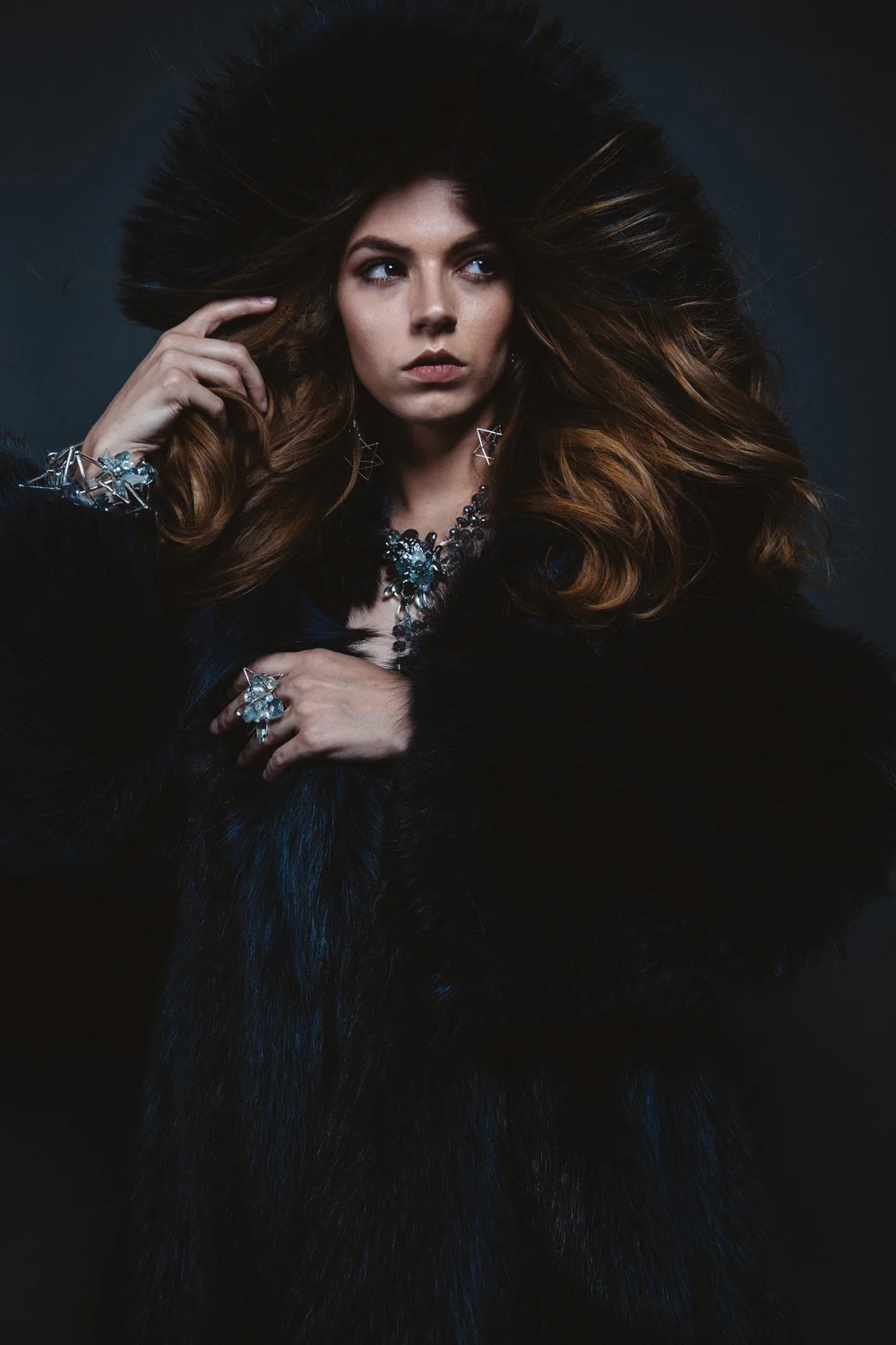 Caitlin wearing Andrea Li's aquamarine jewelry for the Piscine collection, in fur