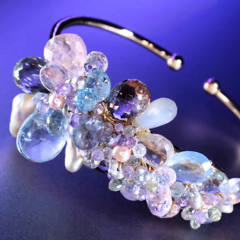A pastel gemstone cuff bracelet from the Tamar collection by Andrea Li, on purple