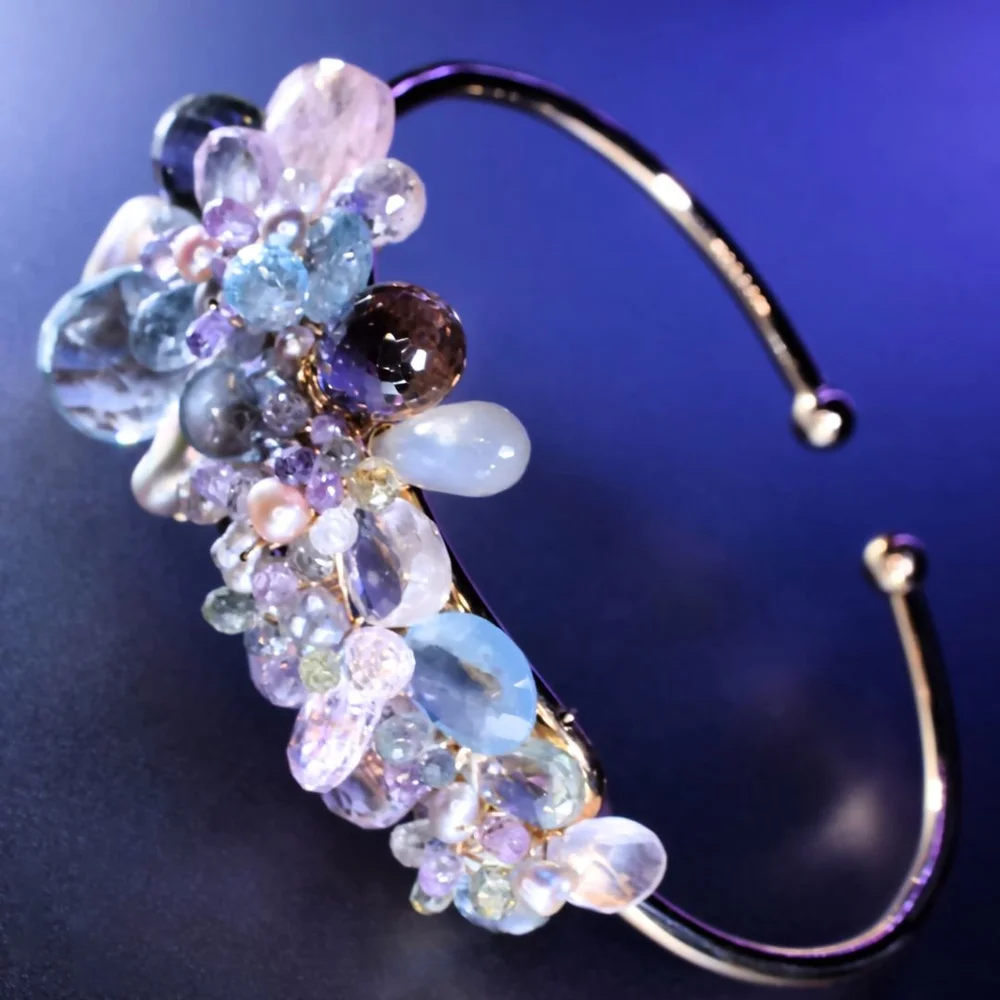 A pastel gemstone cuff bracelet from the Tamar collection by Andrea Li, on purple