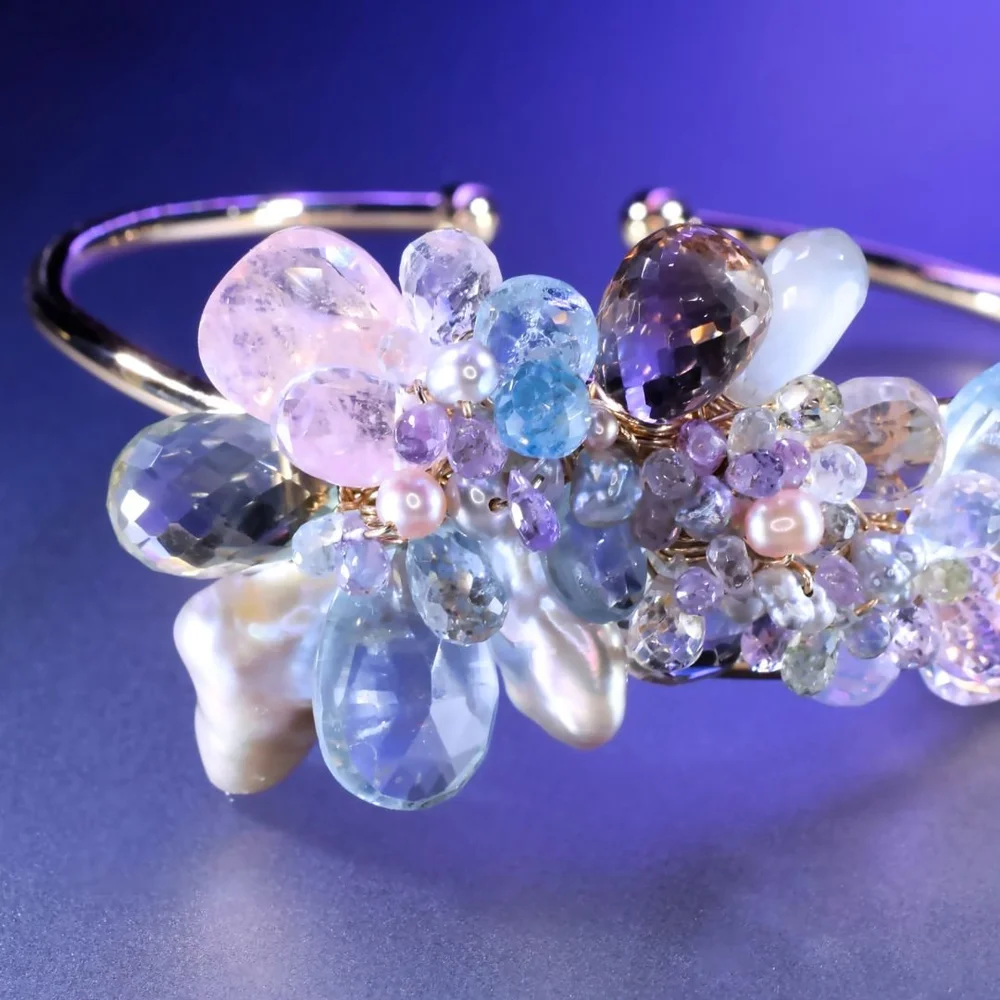 A pastel gemstone cuff bracelet from the Tamar collection by Andrea Li, on purple