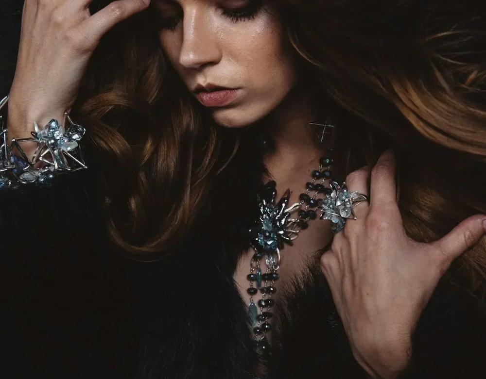 Caitlin wearing Andrea Li's aquamarine jewelry for the Piscine collection, in fur