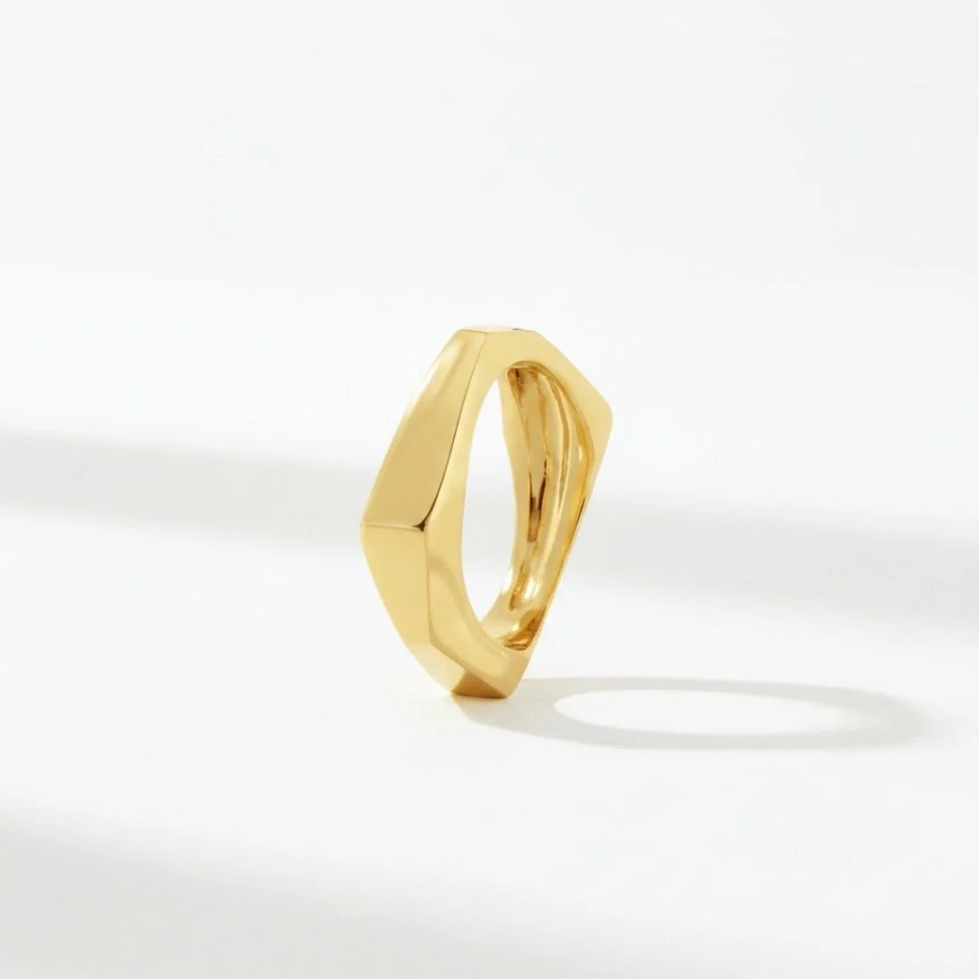 Hand-carved, cast solid 14k gold architectural ring with angular faceted planes.