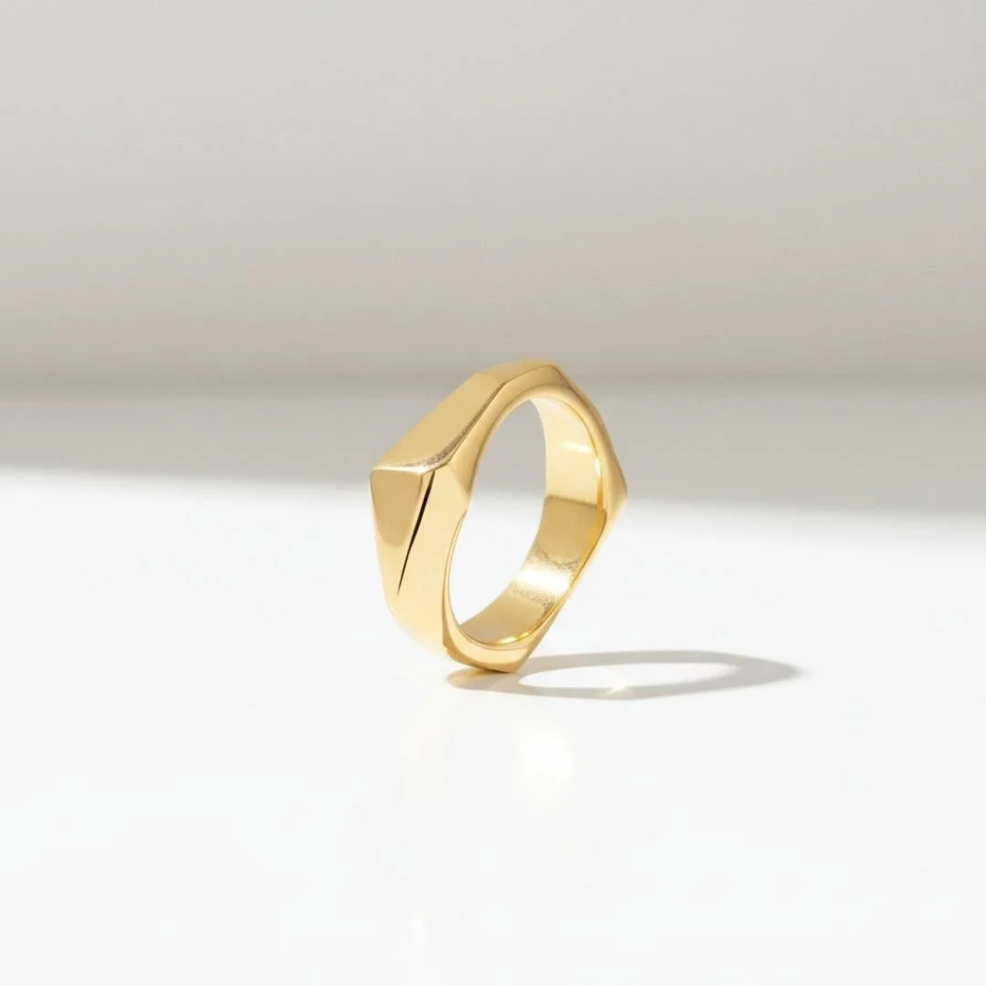 Hand-carved, cast solid 14k gold architectural ring with angular faceted planes.