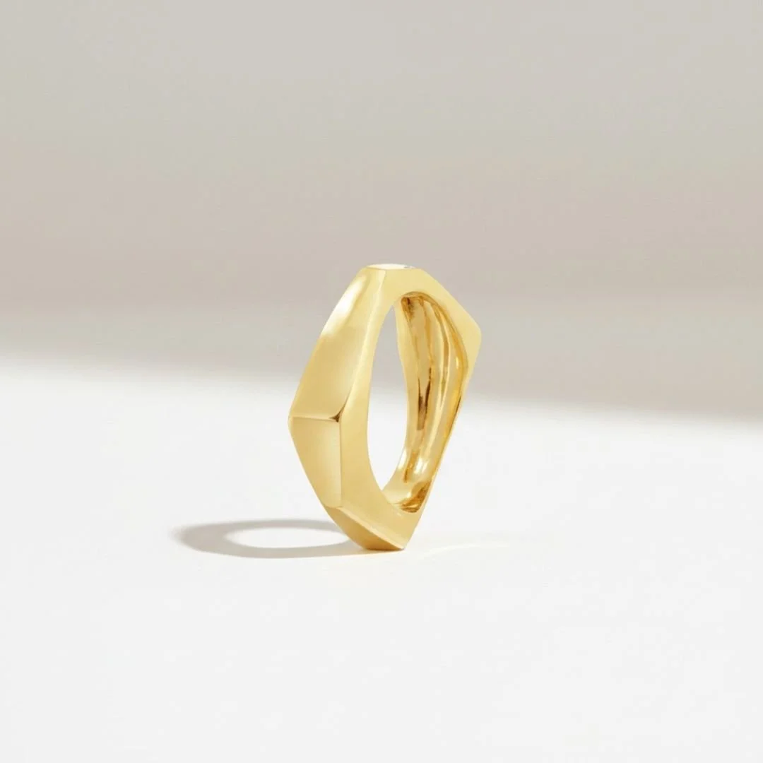 Hand-carved, cast solid 14k gold architectural ring with angular faceted planes.