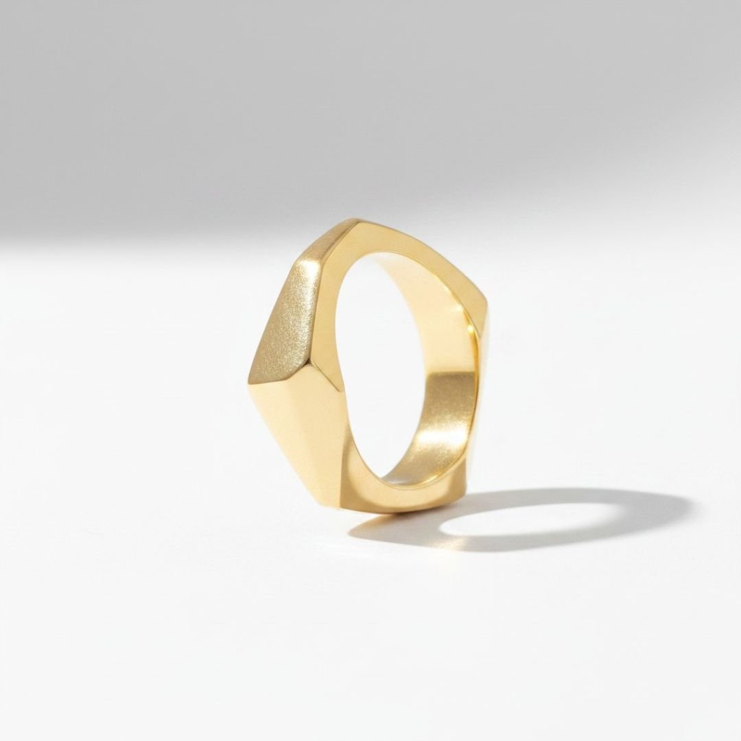 Hand-carved, cast solid 14k gold architectural ring with angular faceted planes.