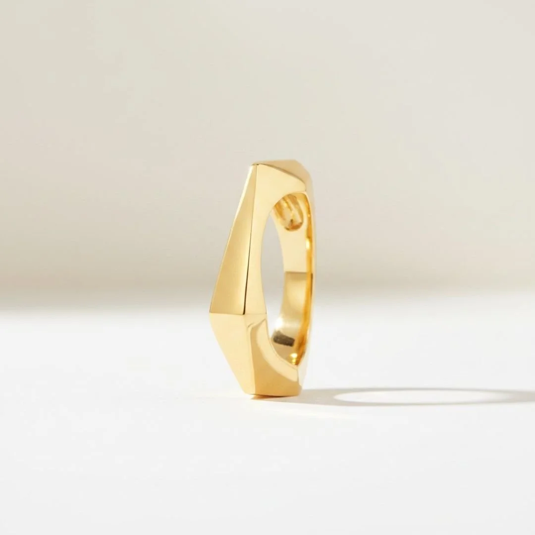Hand-carved, cast solid 14k gold architectural ring with angular faceted planes.