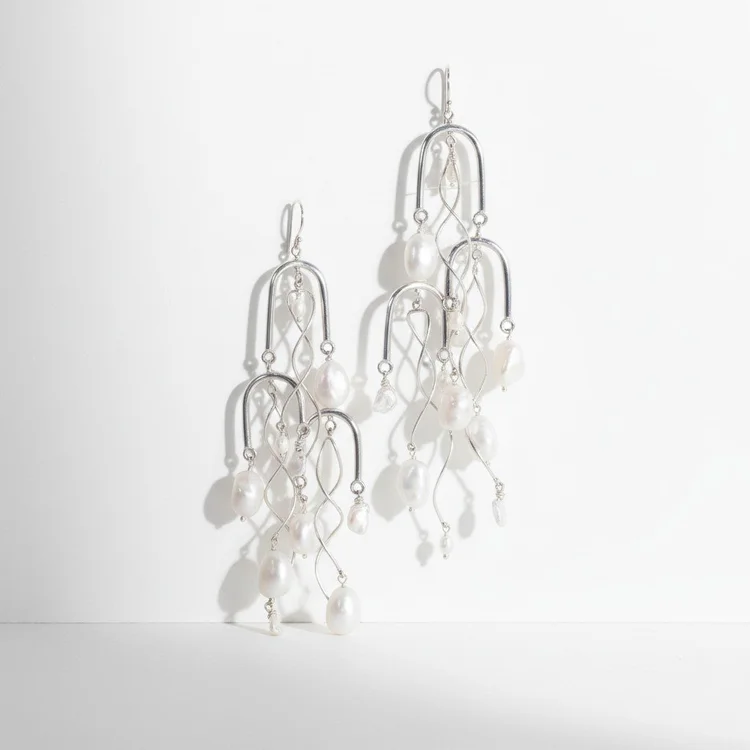 Silver chandelier earrings of tiered wire arches with clear crystal drops