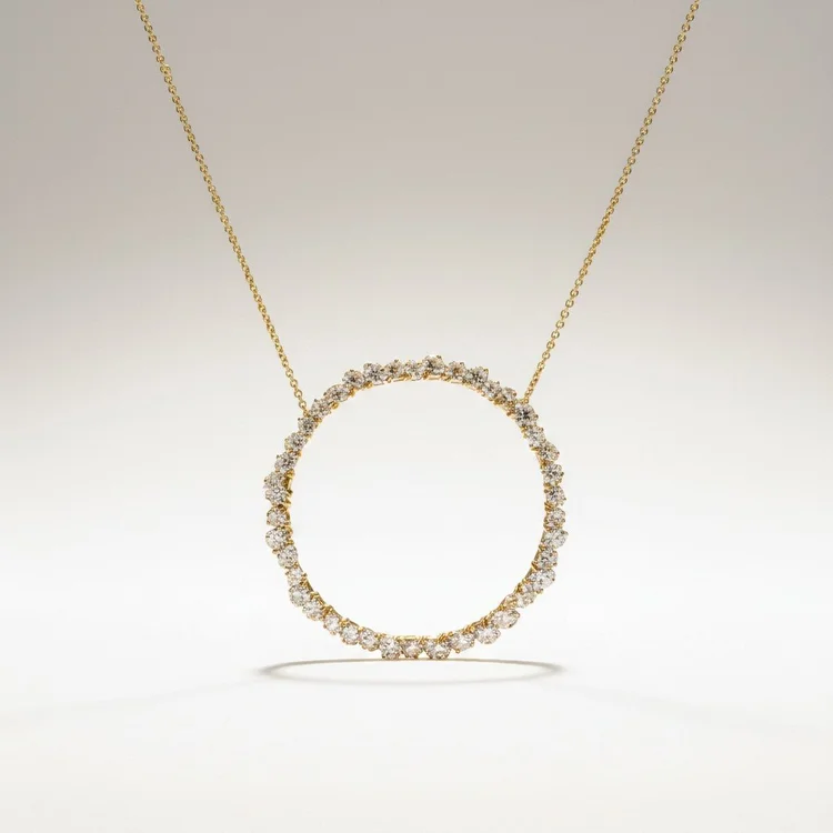 Gold chain with a large open circle pendant set with small clear stones