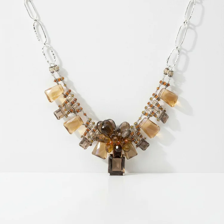 Silver paperclip chain with a collar of brown and honey cube-shaped stones