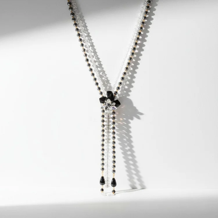 Silver chain lariat with black faceted stones and black teardrops