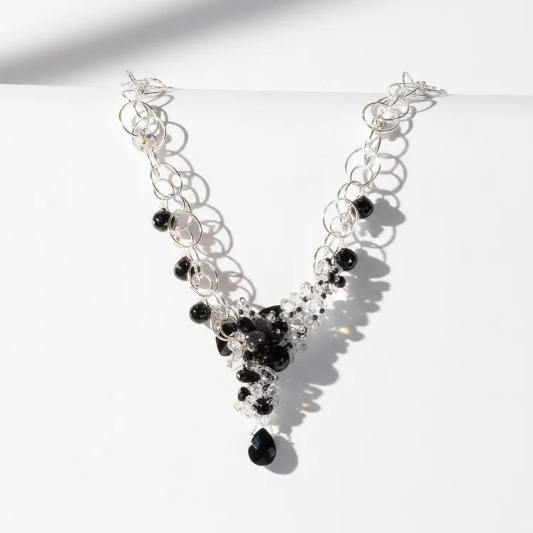Silver circle-link Y necklace with a cluster of black stones and a black teardrop