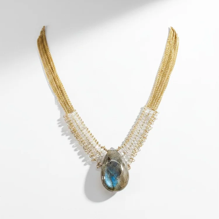 Gold multi-strand seed bead necklace with a gray-blue iridescent teardrop