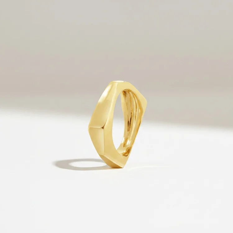 The faceted gold ring turned to its sharpest edge