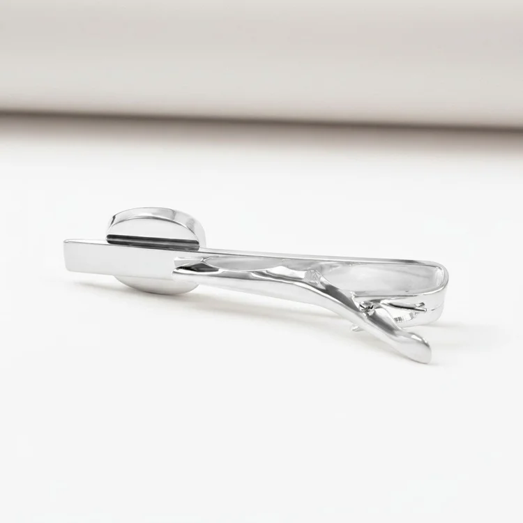Silver tie bar with a pale oval cabochon
