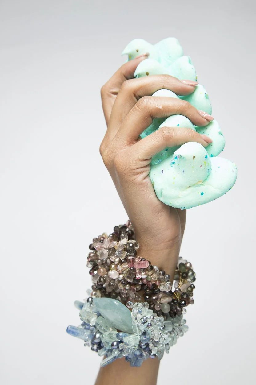 a model of teal marshmallows wearing statement bracelets 