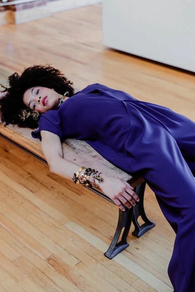 Model in an art gallery for an editorial fashion shoot with tourmaline jewelry