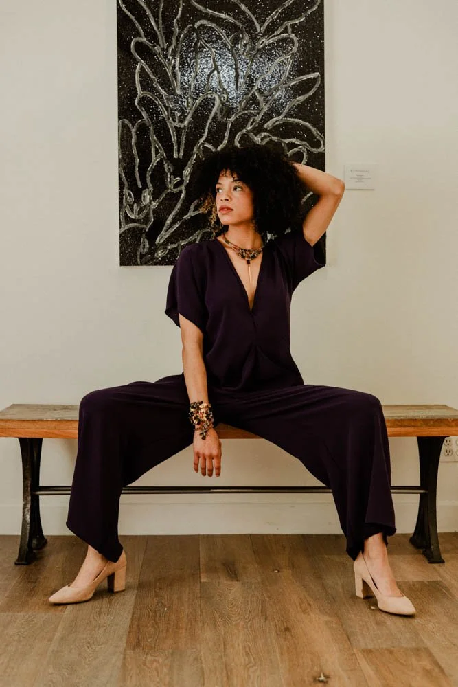 Model in an art gallery for an editorial fashion shoot with tourmaline jewelry