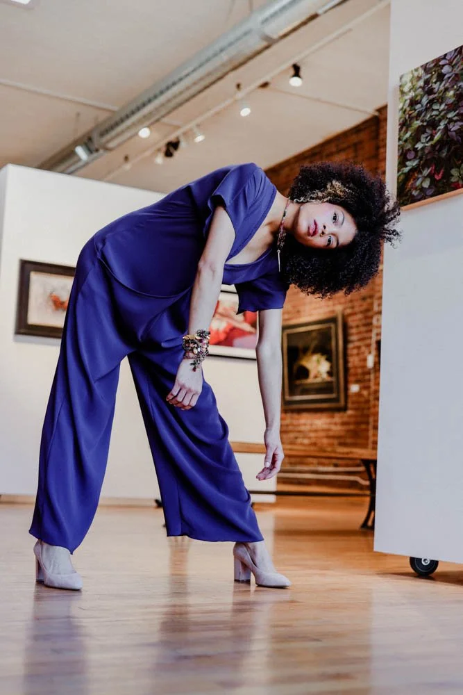 Model in an art gallery for an editorial fashion shoot with tourmaline jewelry