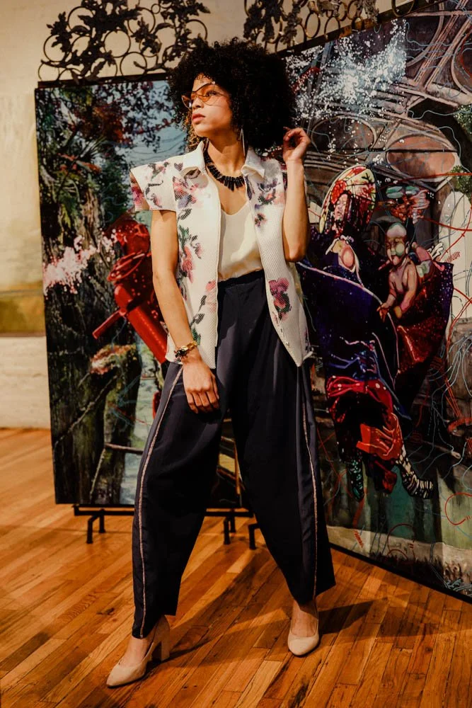 Model in an art gallery for an editorial fashion shoot with tourmaline jewelry
