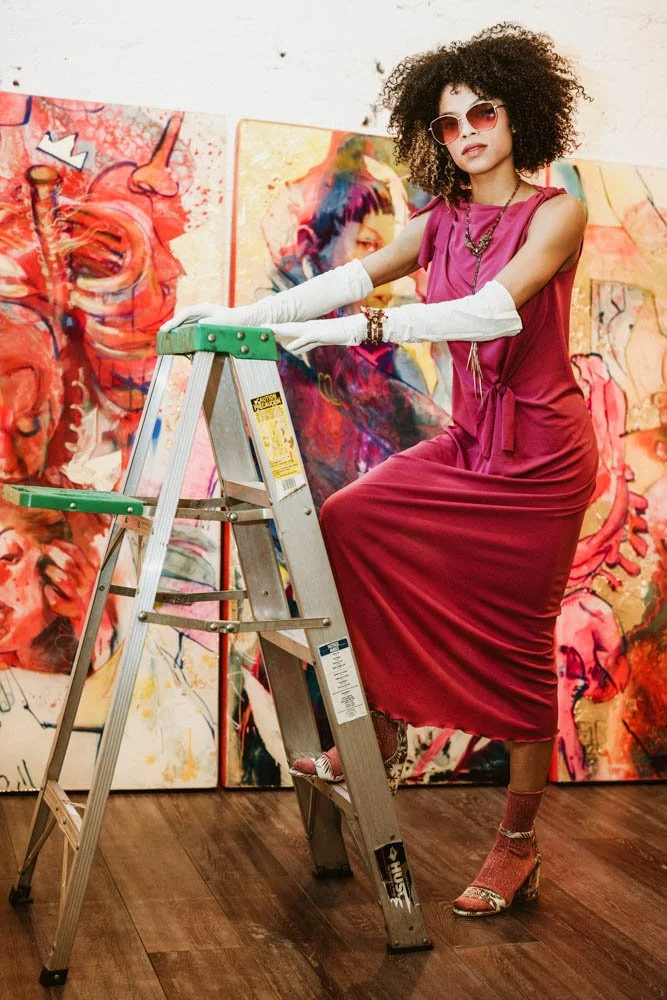 Model in an art gallery for an editorial fashion shoot with tourmaline jewelry