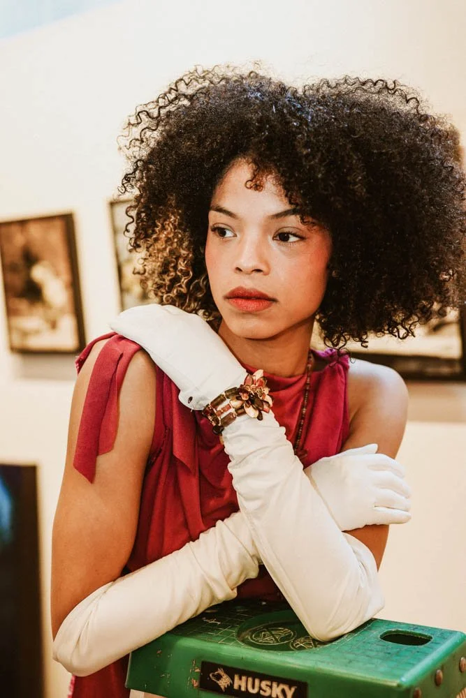 Model in an art gallery for an editorial fashion shoot with tourmaline jewelry