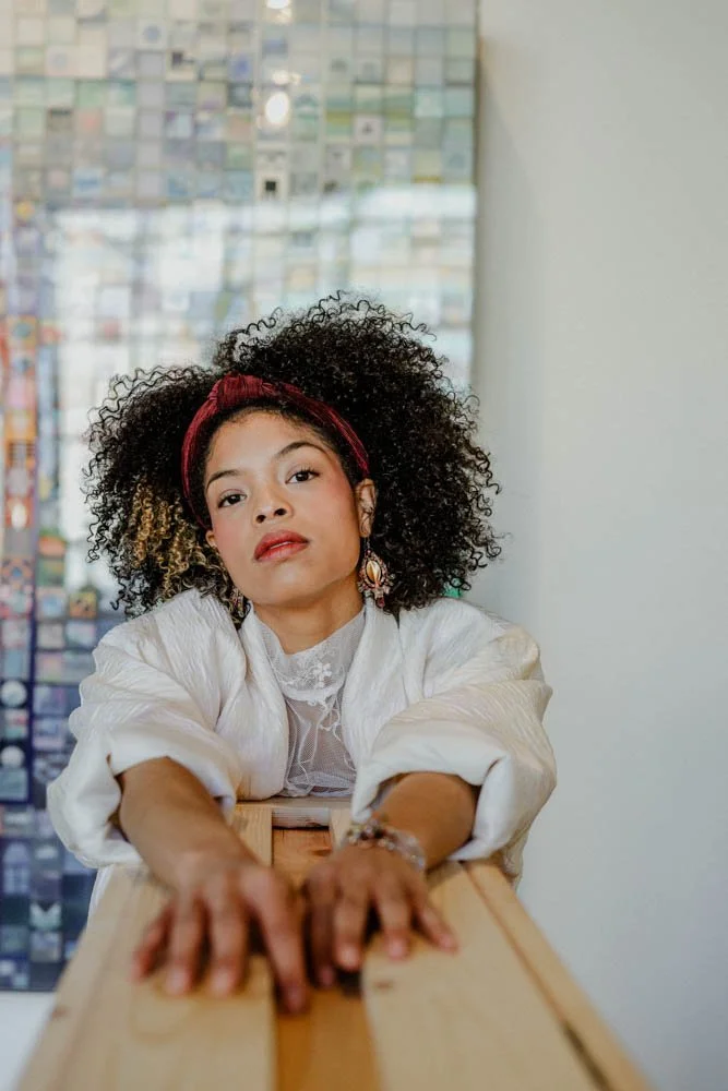 Model in an art gallery for an editorial fashion shoot with tourmaline jewelry